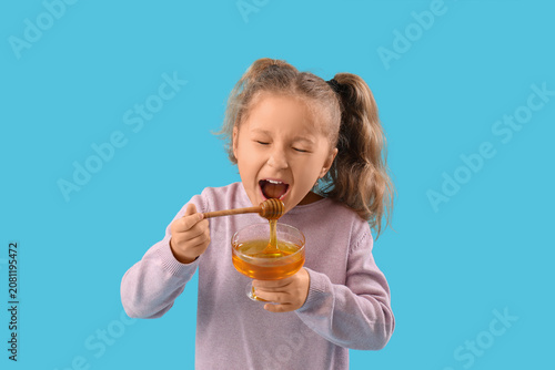 Cute little girl holding bo...