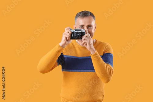 Mature man with photo camer...