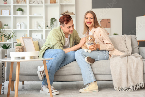 Young couple with cute cat ...