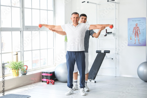 Mature man training with du...