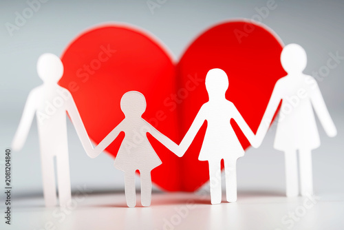 Paper Family Holding Hands with Red Heart Background
