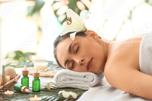 Young woman relaxing in spa...