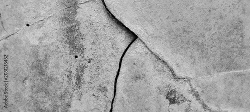 Cracked concrete wall texture with weathered gray cement surface