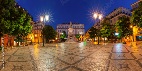 Panoramic view of Luis de Camoes Square illuminated at blue hour in Lisbon, Portugal.