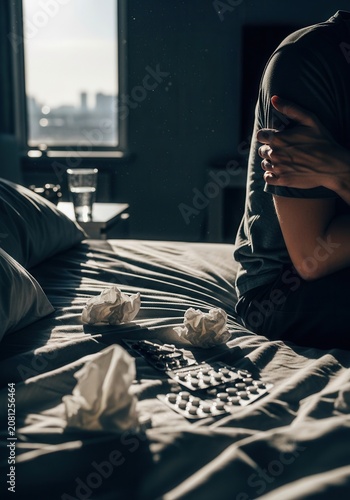 Person Experiencing Illness And Taking Medication On Bed In Sunlight