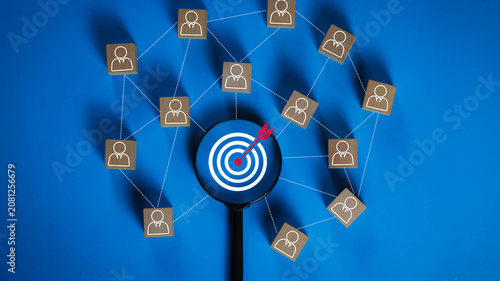 Cuadro en lienzo Business target audience analysis with magnifying glass focusing on a goal icon connected to a professional network