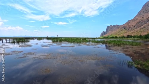 panoramic view of the mirror-like surface of the lake and towers in the distance
