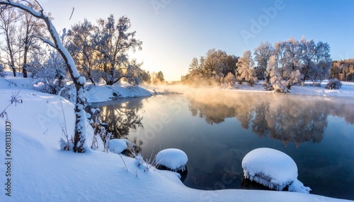 Serene Winter Landscape - Snow-Covered Trees and Reflective River at Sunrise.