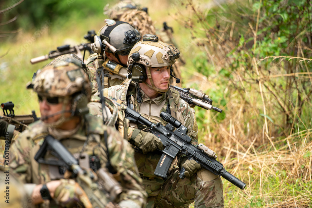 Fototapeta premium Special operations soldiers maintain concealment and observation while conducting reconnaissance