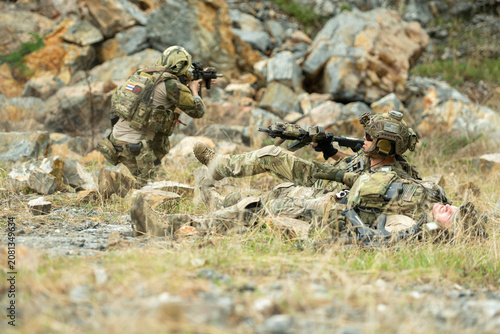 фотографія Military personnel practice movement, evasion, and taking cover after a simulate