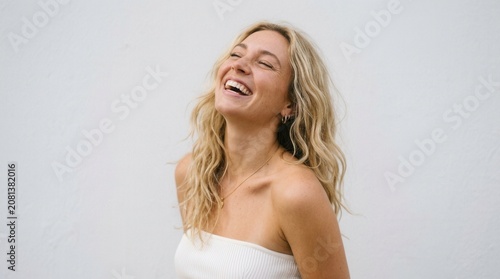 Radiant Blonde Woman Smiling Joyfully After Beauty Treatment in Spa Salon, Feeling Attractive with clear skin smiles joyfully