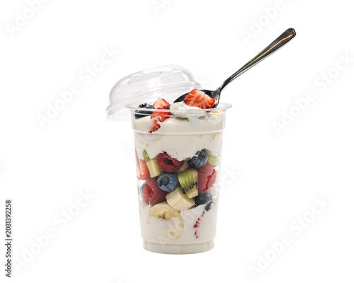 Fruit yogurt parfait in clear plastic cup with spoon isolated on a transparent background