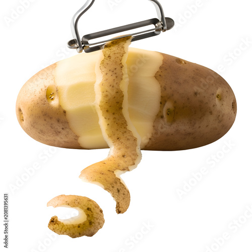 Potato being peeled with vegetable peeler.