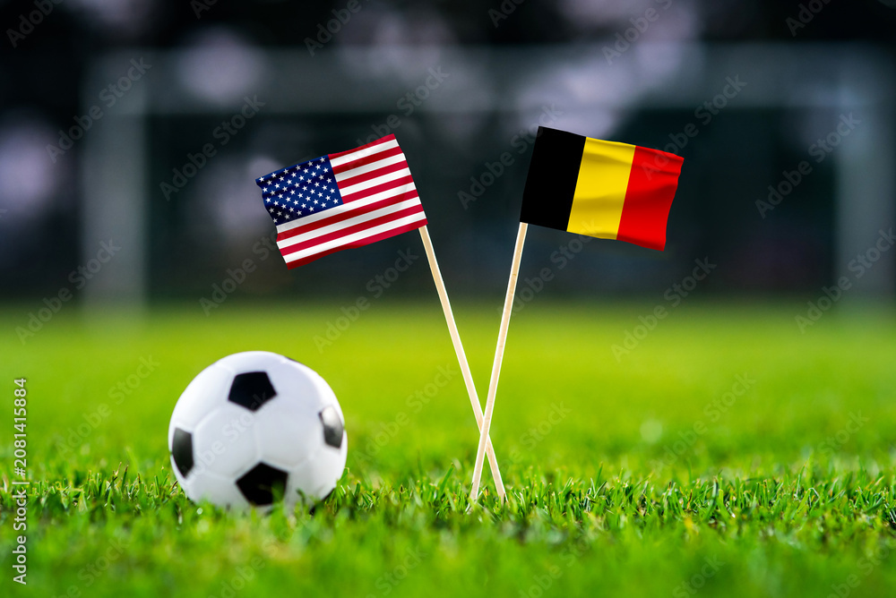 Fototapeta premium United States vs Belgium, national flags before international football match, football on green grass with stadium in the background, Lumen Field, Seattle, United States, July 6, 2026