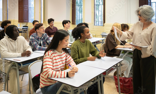 Tableau sur toile Teacher interacting with diverse students attending lecture in university classr