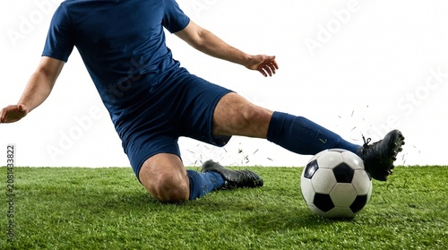 Anonymous football defender performing sliding interception isolated on white background