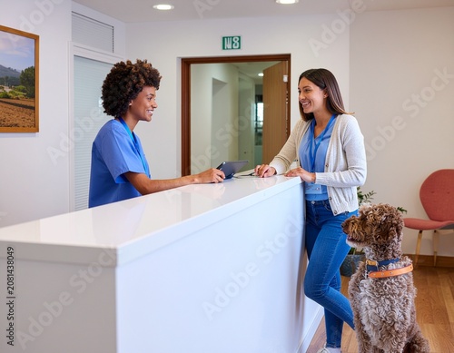 Veterinarian and woman with dog at clinic.