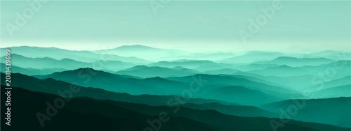 Photos Misty mountain range in serene turquoise hue, layered peaks receding into atmospheric haze, evokes sense solitude and vastness