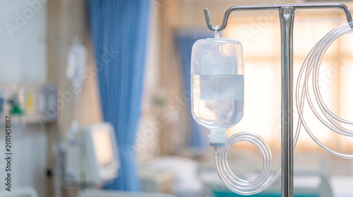 Obraz na plátně Medical intravenous drip bag and tubing in hospital room