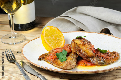 Cooked Fish Fillets with Lemon and Parsley on Wooden Table