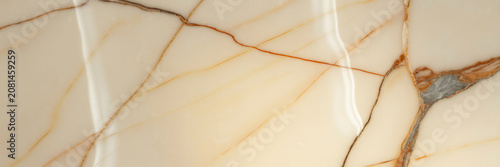 Beautiful polished beige marble slab texture with elegant brown and gold veins for luxury interior design and architecture surface background
