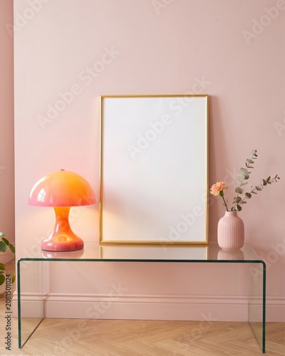 Blank gold frame mockup on glass console with glowing orange mushroom lamp and pink wall