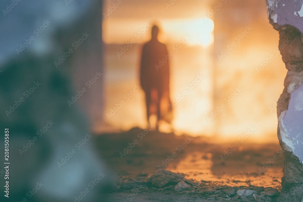 Fototapeta premium Atmospheric abandoned interior space with a small human silhouette standing in golden light for halloween posters, horror movie concepts and moody book covers
