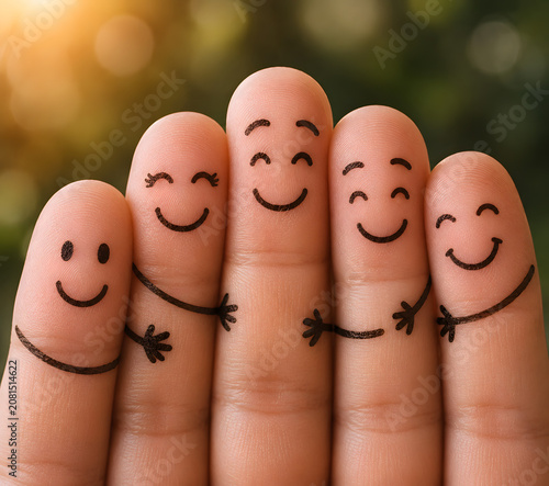Five fingers with drawn happy faces hugging isolated on a transparent background