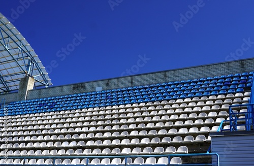 Quadro su tela Grandstands of Empty Stadium with Steel Roof Structure