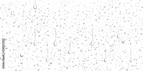Fotografie Condensed water droplets creating streaks on clear glass window with droplets tr