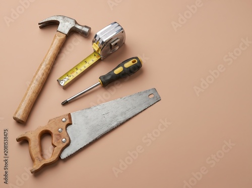 Carpenter Tools on Pastel Brown Background Construction Concept
