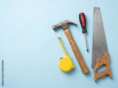 Carpenter Tools on Pastel Blue Background Construction Concept