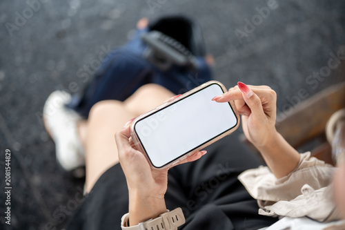 Close up of woman holding smartphone with blank screen.