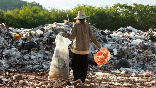 Obraz na plátně Woman Cleaning Plastic Waste at Landfill to Support Recycling, Environmental Pro