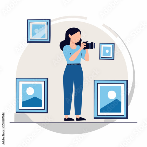 Woman taking photos of framed pictures.