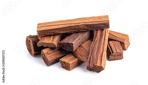 A pile of natural sandalwood wood pieces isolated on a pure white background, aromatic hardwood chunks with rich brown texture