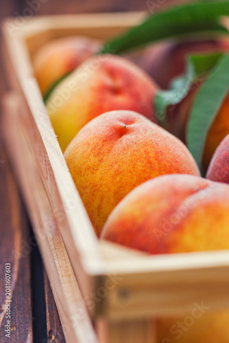 Fresh peaches in a wooden basket