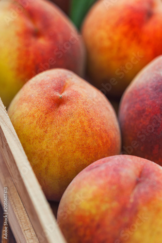 Fresh peaches in a wooden basket