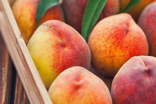 Fresh peaches in a wooden basket