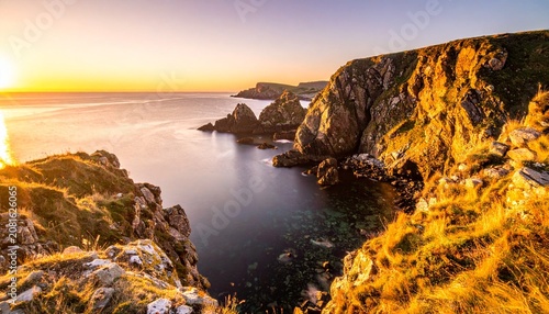 Golden hour over dramatic rocky canyon river landscape.