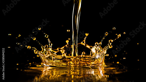 Elegant splash of golden liquid against a dark background, capturing the beauty and movement of fluid dynamics.