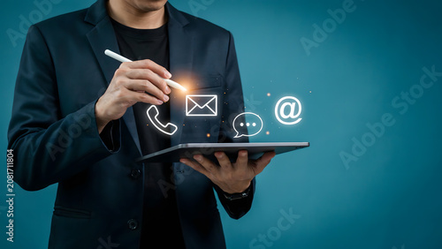Businessman interacting with digital communication icons on a tablet