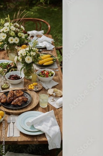 Summer Gathering With Food and Drinks on a Wooden Table in an Outdoor Setting