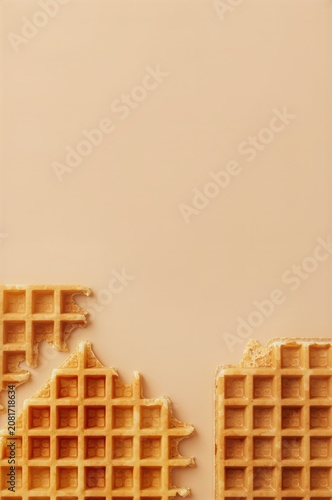 Waffles Lie on a Flat Surface With a Light Brown Background at a Kitchen Setting