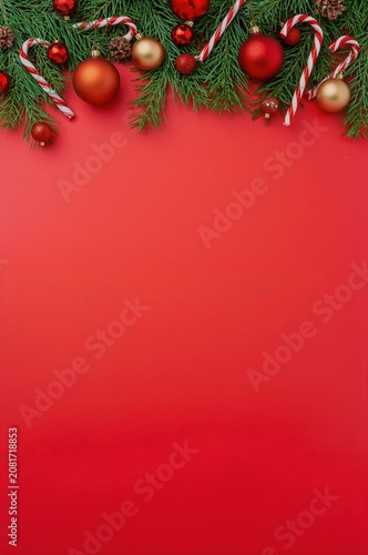 Christmas Decorations With Red Backdrop and Green Pine Branches During Holida...