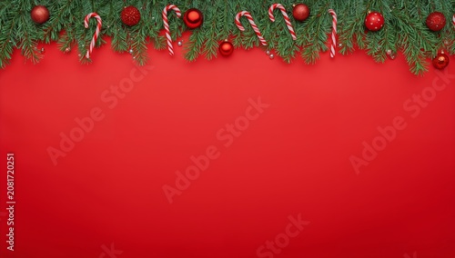 Holiday Decorations With Red Background and Green Foliage in Winter