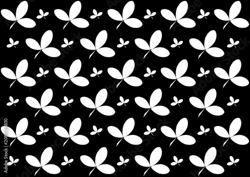 White clover leaf silhouettes seamless pattern on black background, bold monochrome botanical nature repeat illustration.