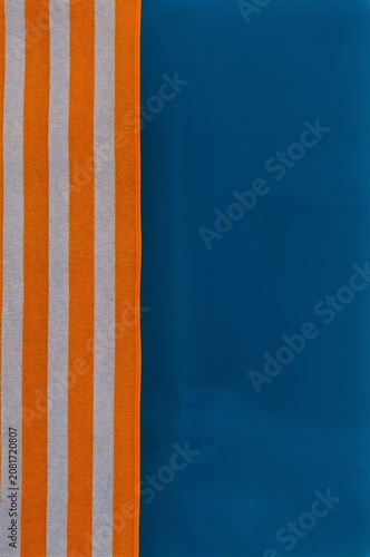 Colorful Striped Towel Next to Solid Blue Towel on a Flat Surface During Dayl...
