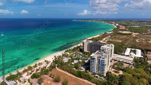 Seven Mile Beach, Cayman Islands: Aerial drone view of Grand Cayman Island with turquoise water, white sandy shoreline, luxury resorts, and tropical coastline - landscape panorama of Caribbean Sea
