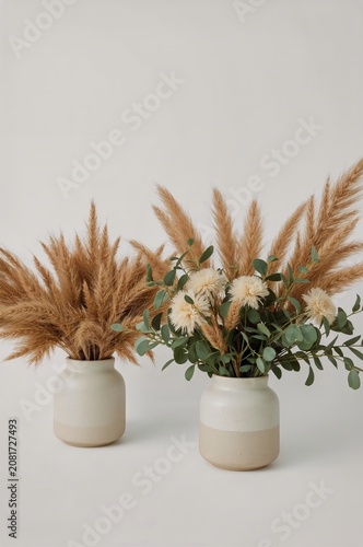 Two Vases With Dried Flowers and Greenery on a Light Background in a Simple I...